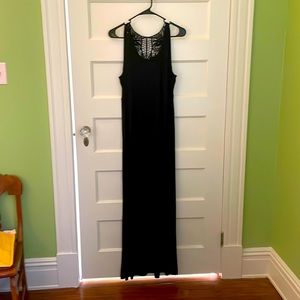 Long black dress worn a few times. Beautiful cutout fabric at the top back.
